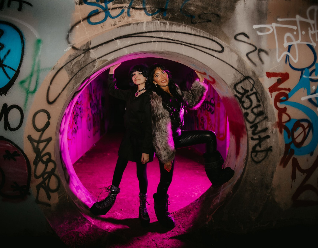 Sophia and Farrah psing together in a tunnel like structure.