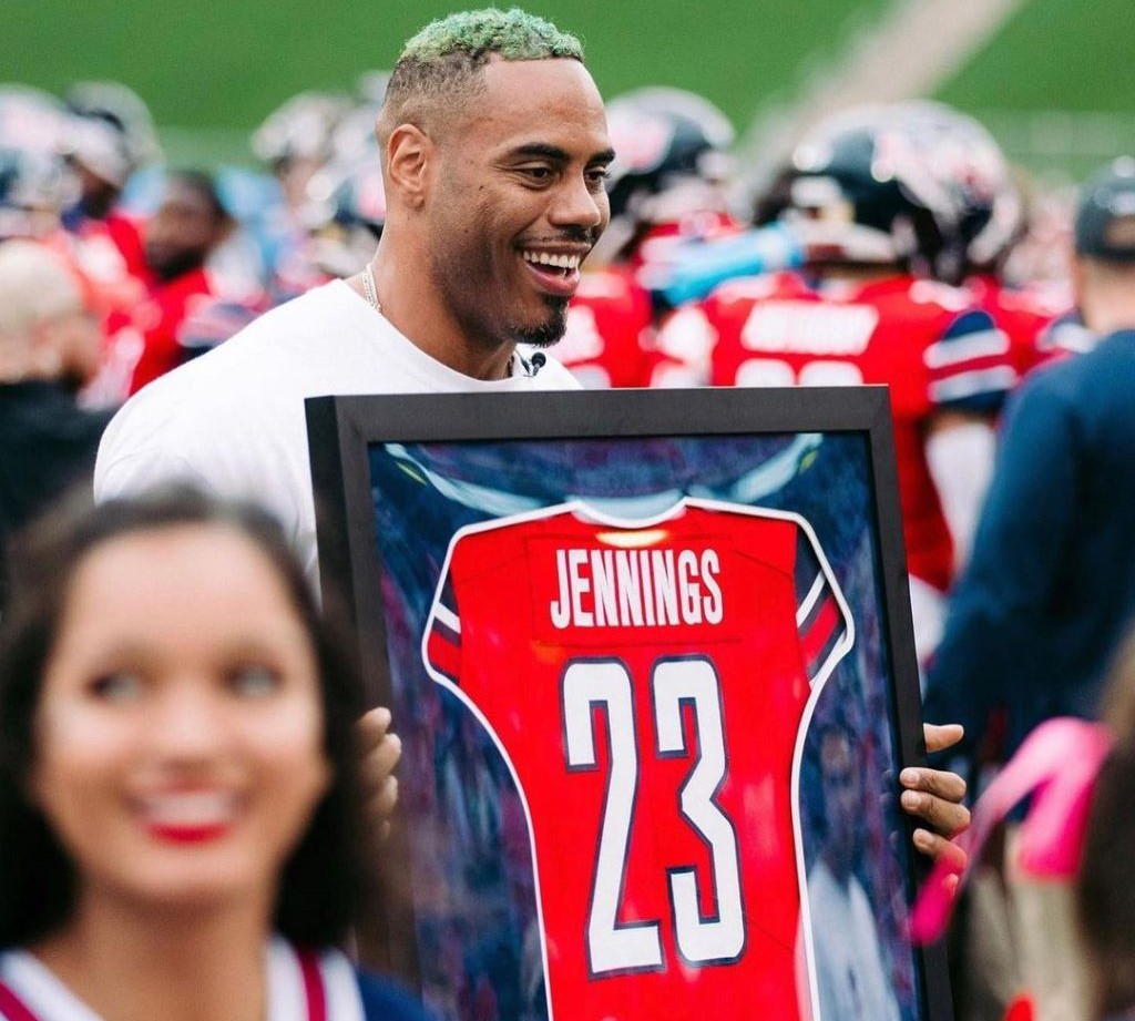 A happy and emotional picture of Rashad Jennings carrying the frame of his jersey in his hand. .
