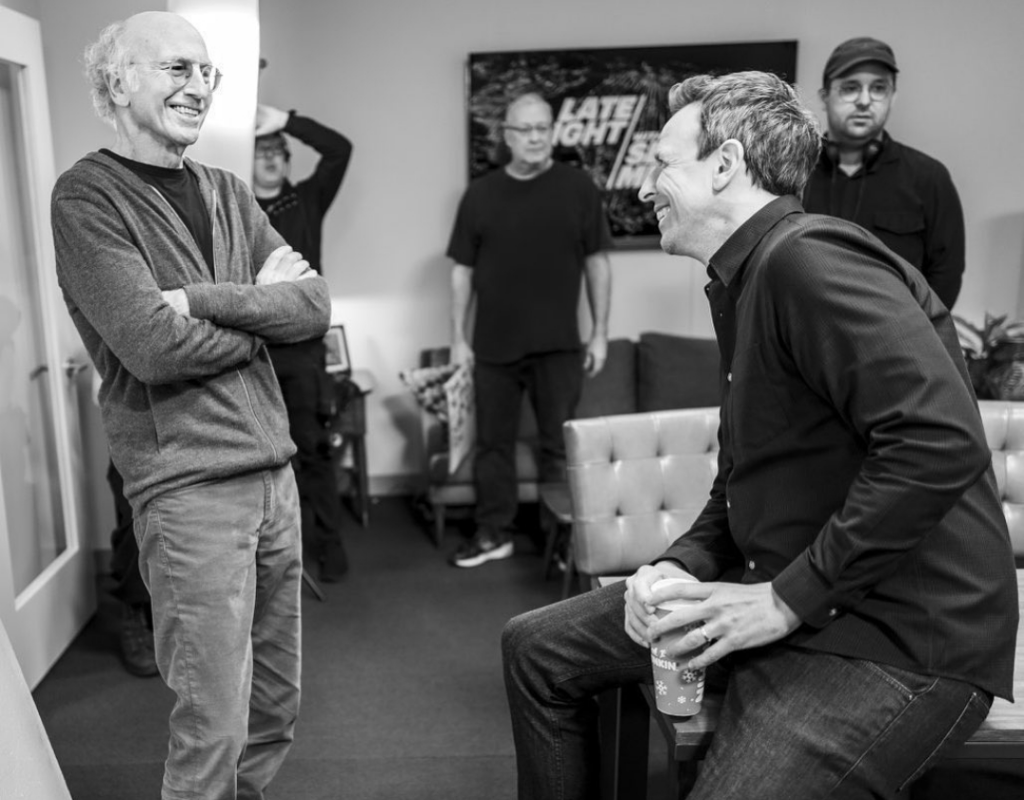 Seth laughing with Larry David while having a conversation