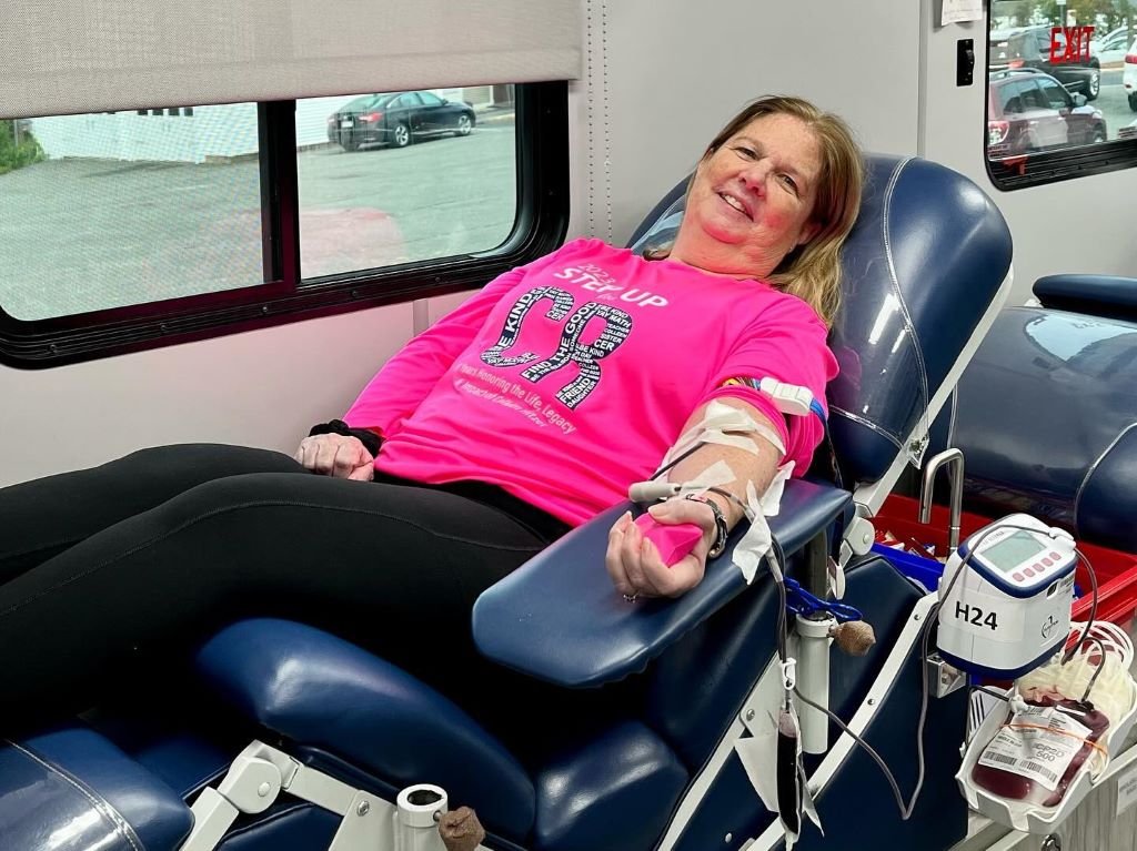 Colleen Ritzer Mother donating blood wearing pink.