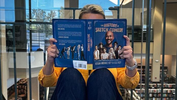 Elle key a non Jewish holding a book she recently published..