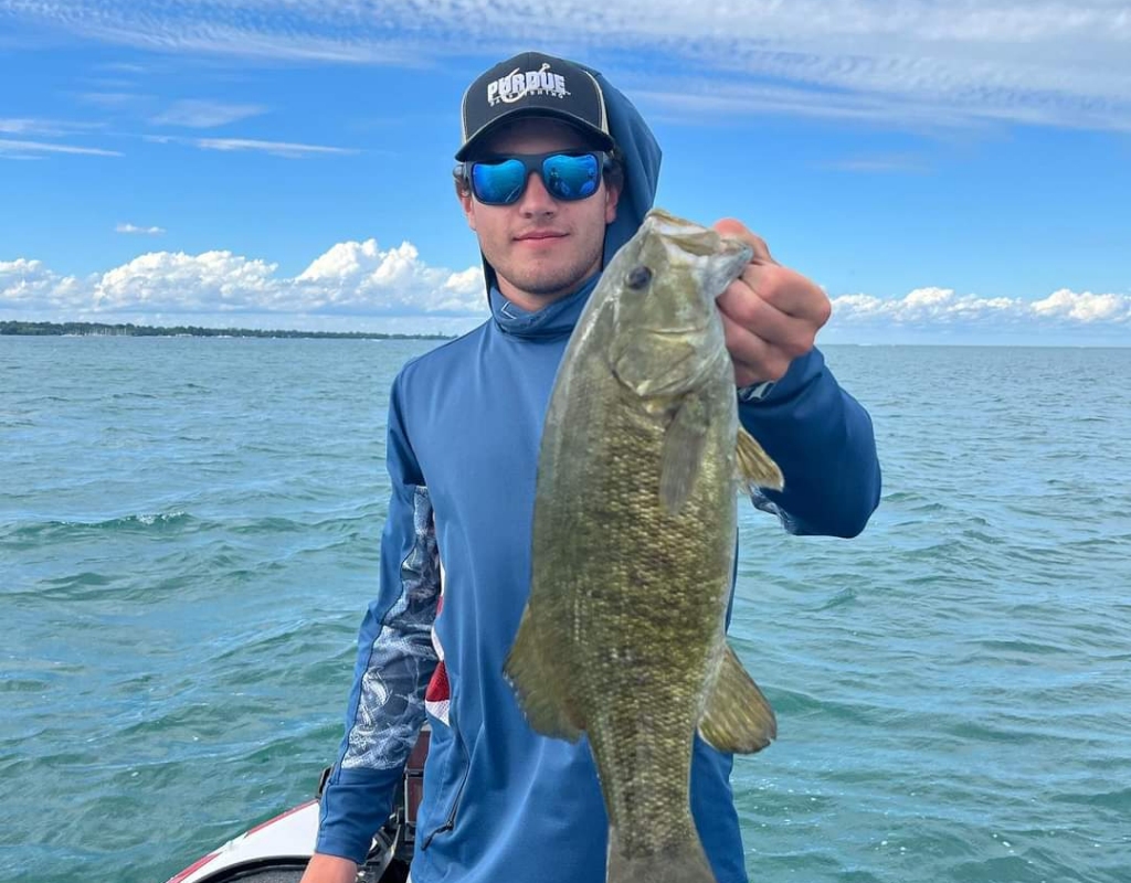 Hunter Heckman's companion Travis Ely posing with a fish