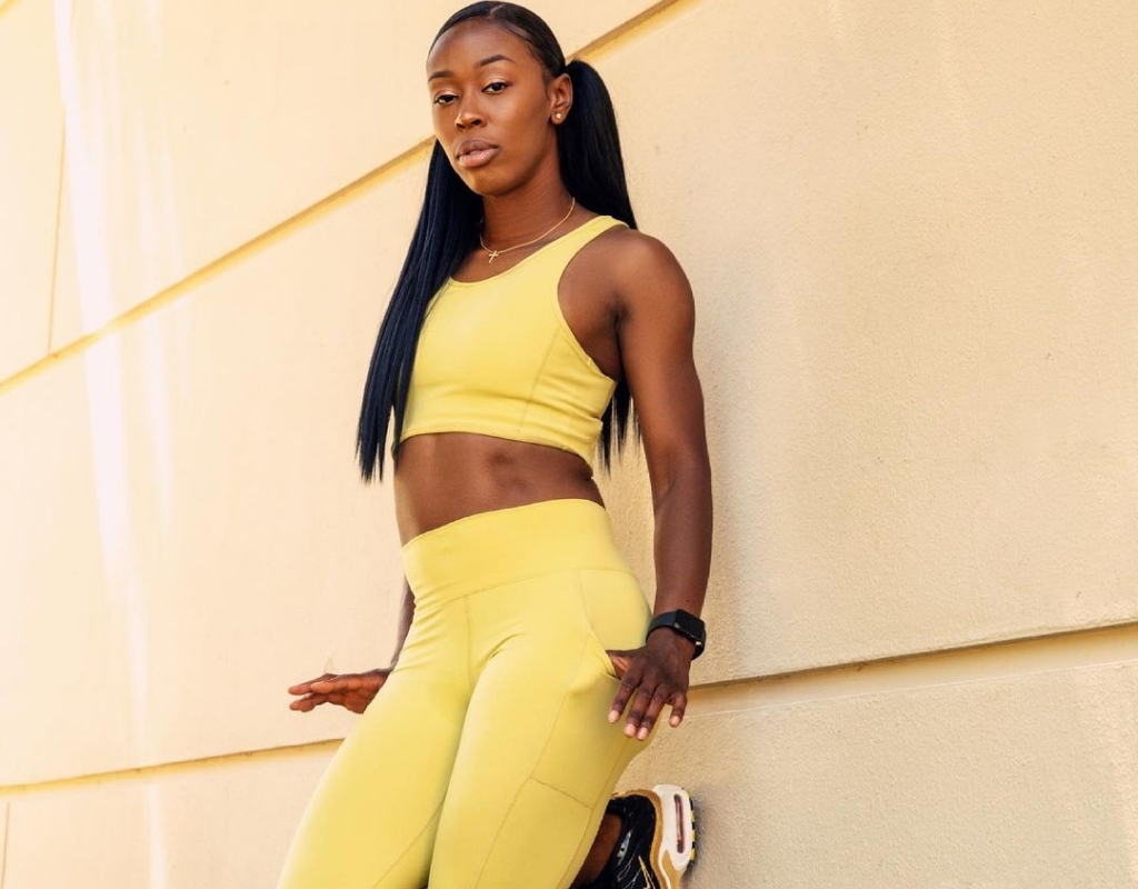 Tyleah Hampton taking a picture in an yellow track suit