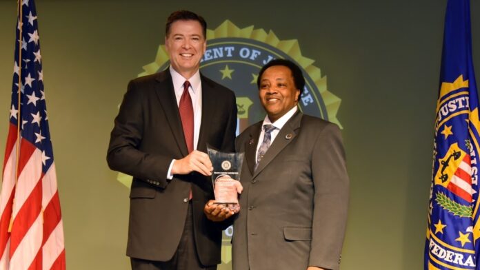 Andrew Holmes received an award from the FBI