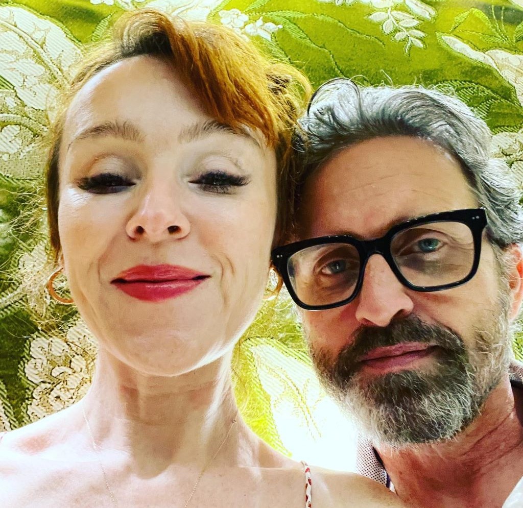 Ruth Connell and her husband smiling 