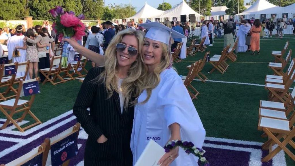 Eden wide smile hugging her mother on her graduation day