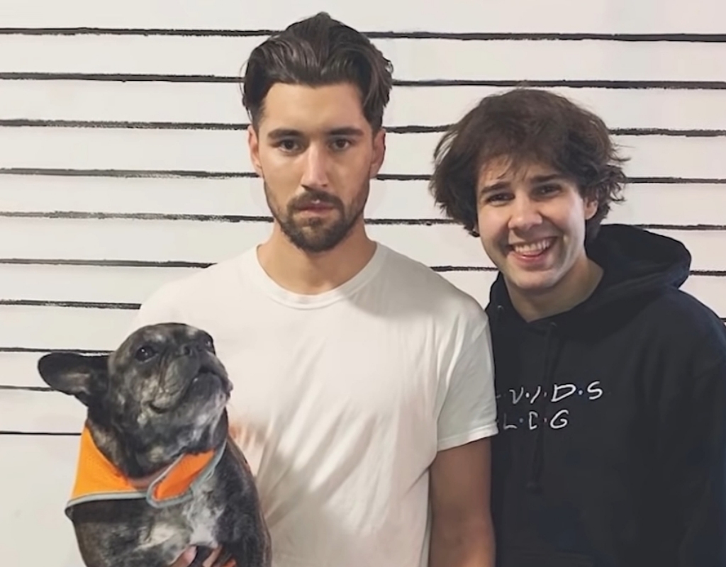 Jeff Wittek taking a picture with David Dobrik while holding a dog in one hand