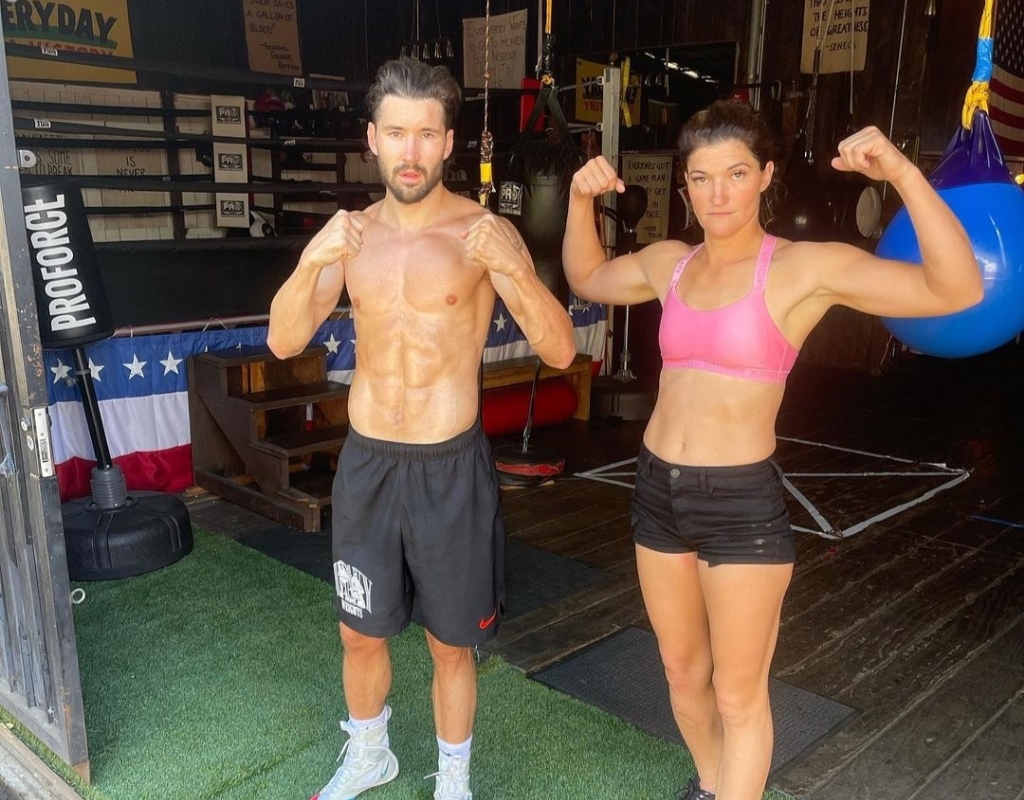Jeff posing with Karyn in a gym