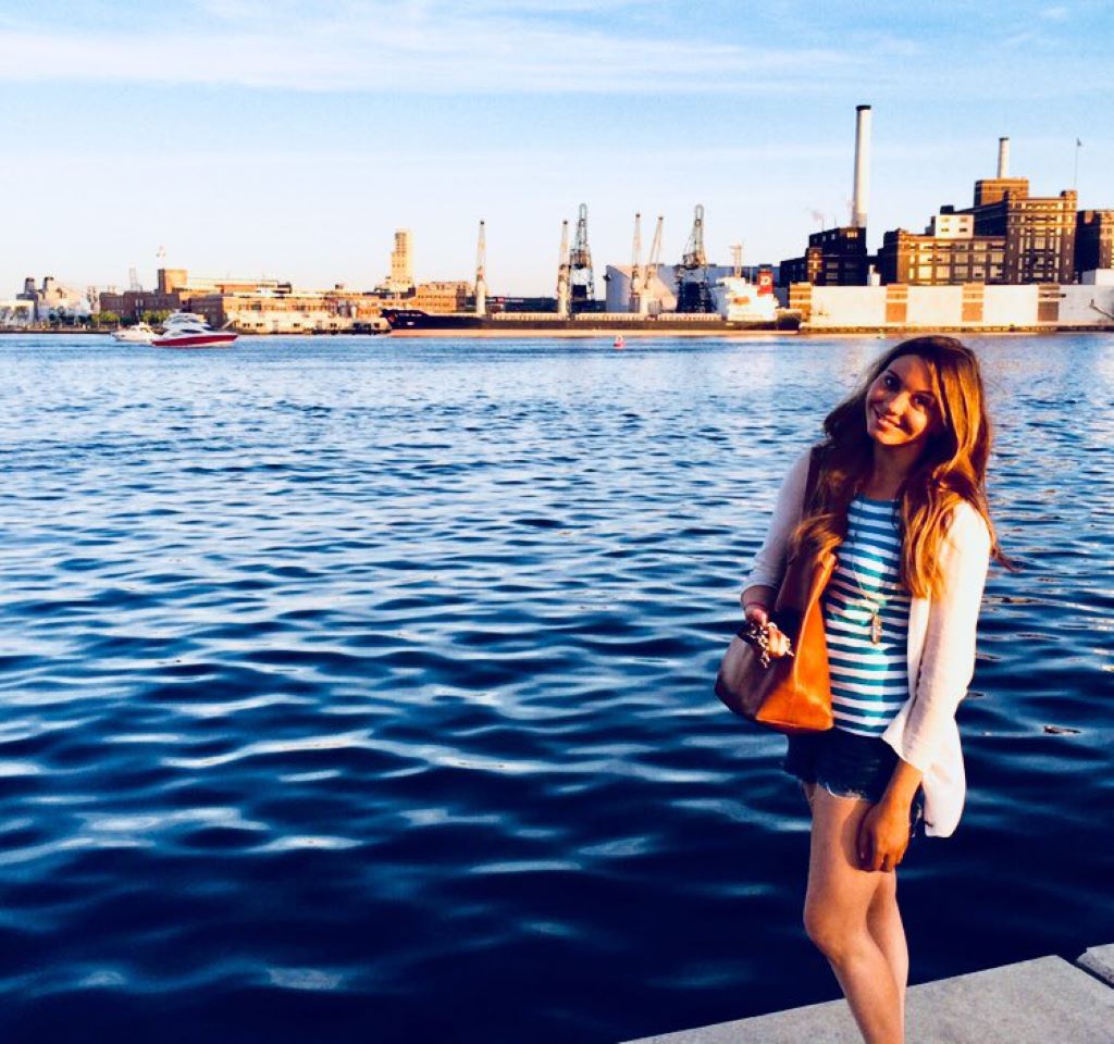 Kerri Kupec in front of ocean standing and smiling 