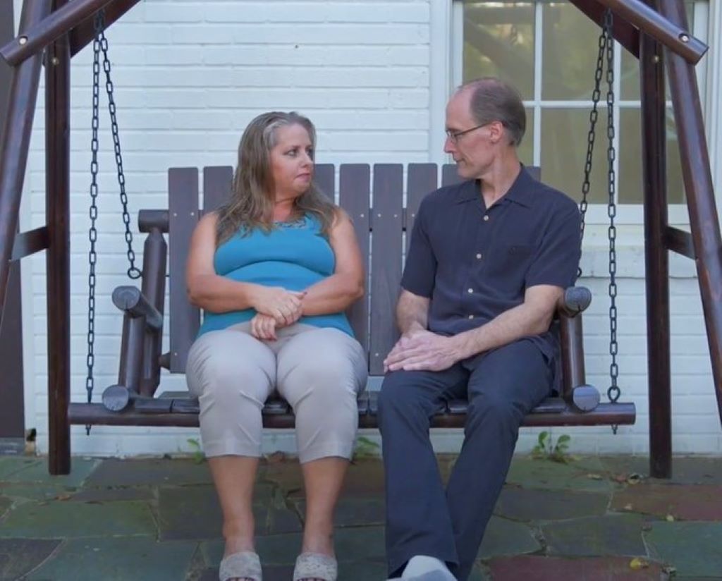 Kim and Barry talking while sitting in swing 