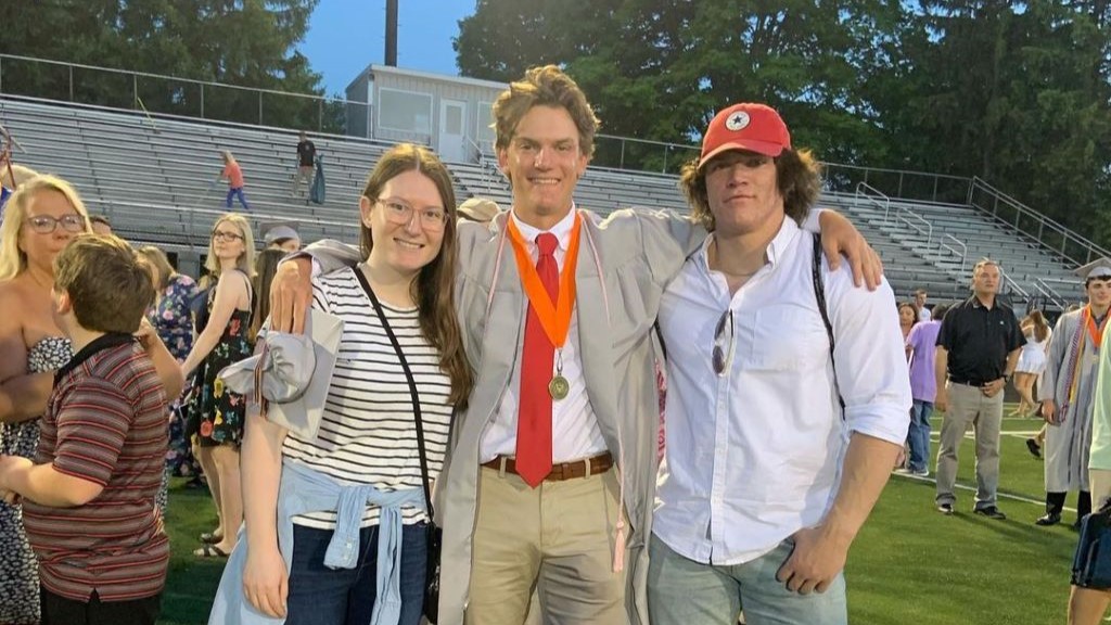 Mark with his sister and brother at his graduation.