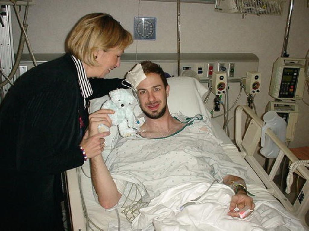 Michael Skolnik in hospital bed alongside his mother 