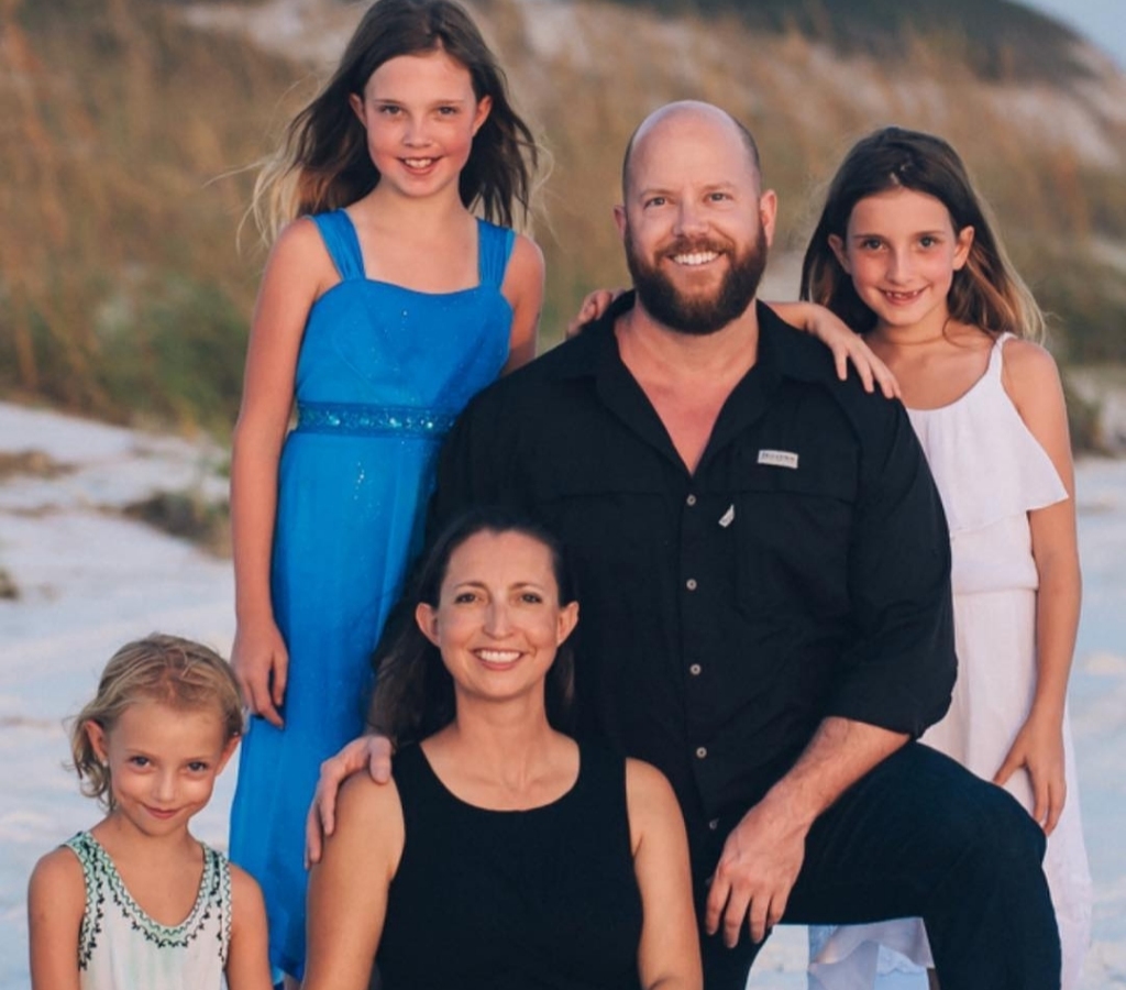 Aaron Smith-Levin taking a picture with his family at Santa Rosa Beach