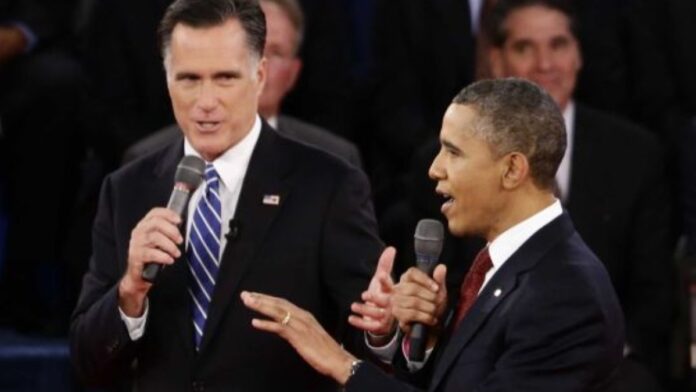 Obama is speaking on the mic with Romney by his side