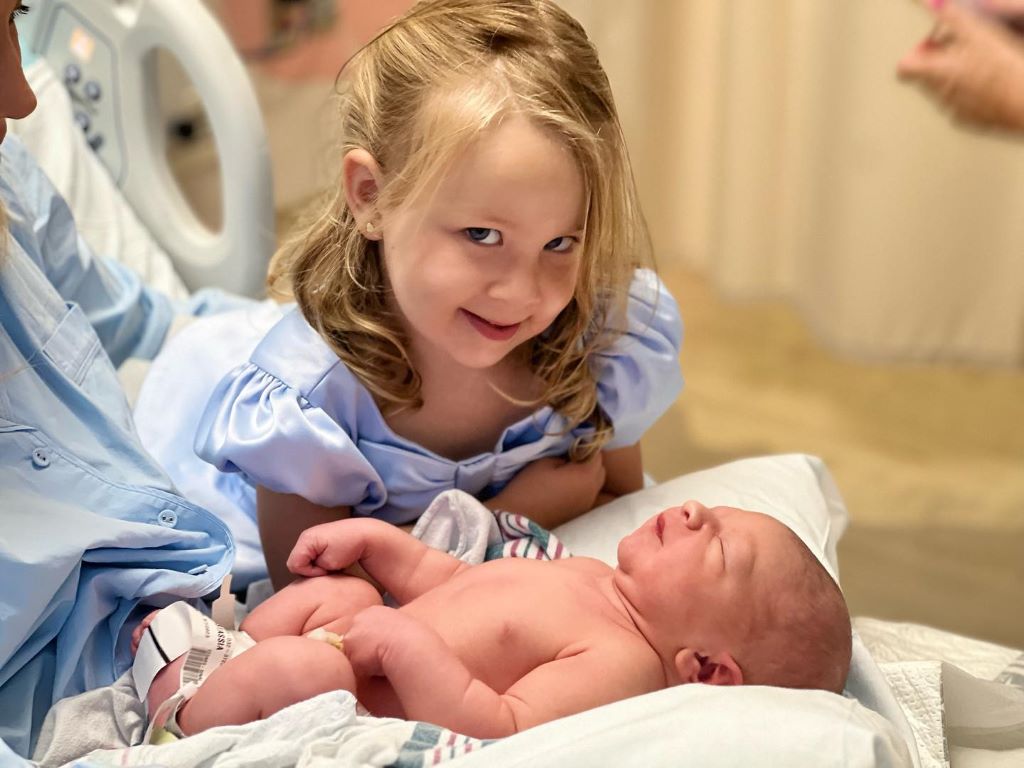 Beau's daughter staring in camera with her newly born brother 