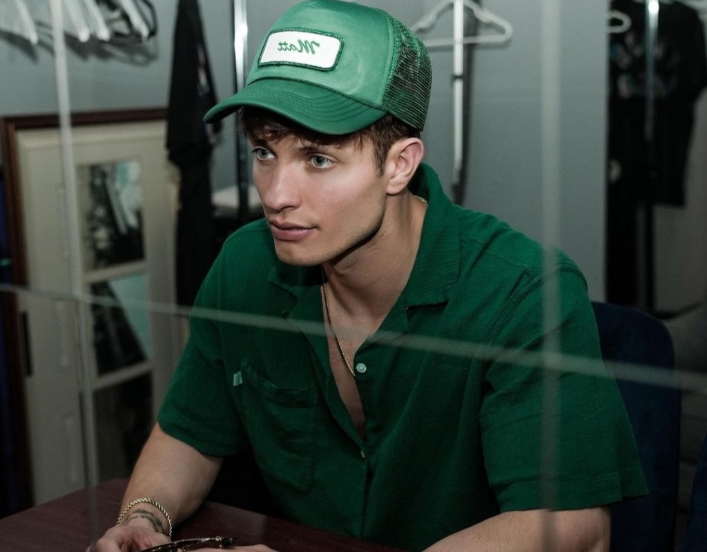 Matt taking a picture in a green shirt and cap