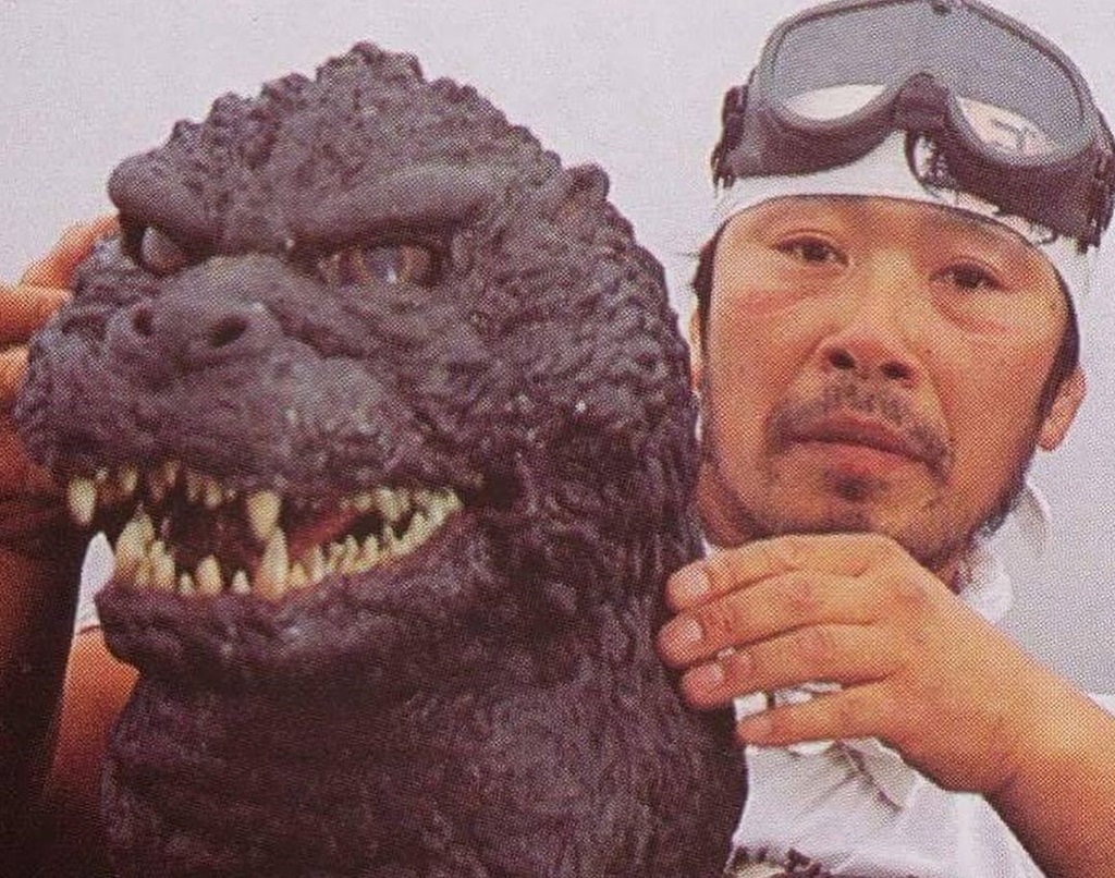 Kenpachiro Satsuma giving pose with a monster from Godzilla.