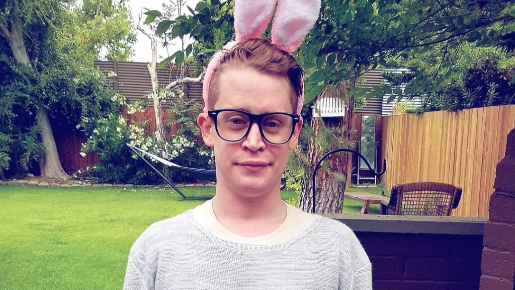 Macaulay with a red hairband that looks like rabbits ear and spectacle.