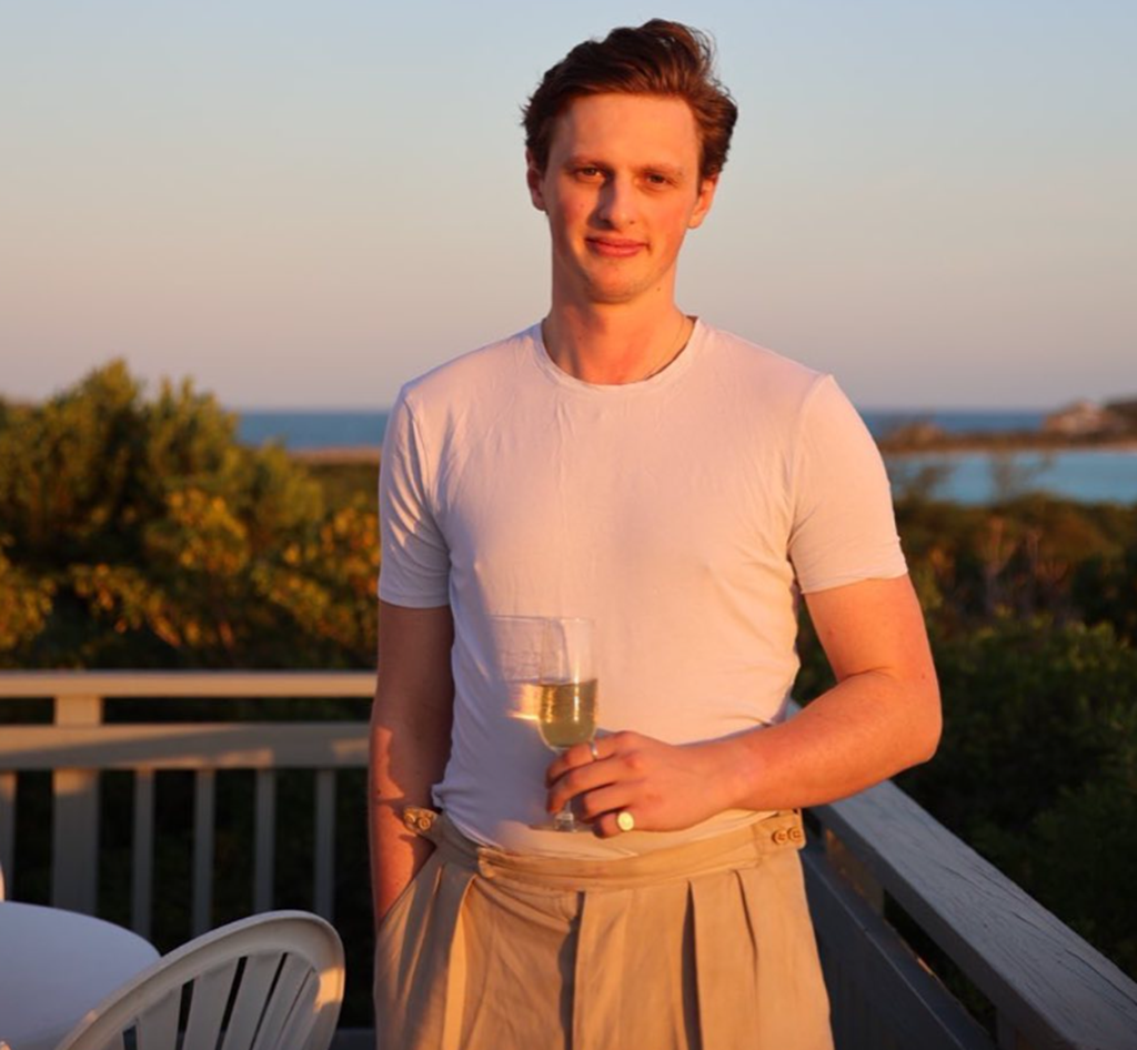 Max Fosh holding a wine glass