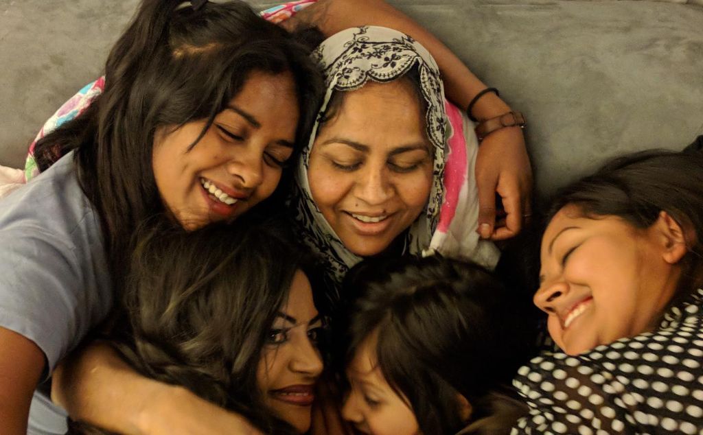 Raisa Kuddus and her siblings hugging their mother.