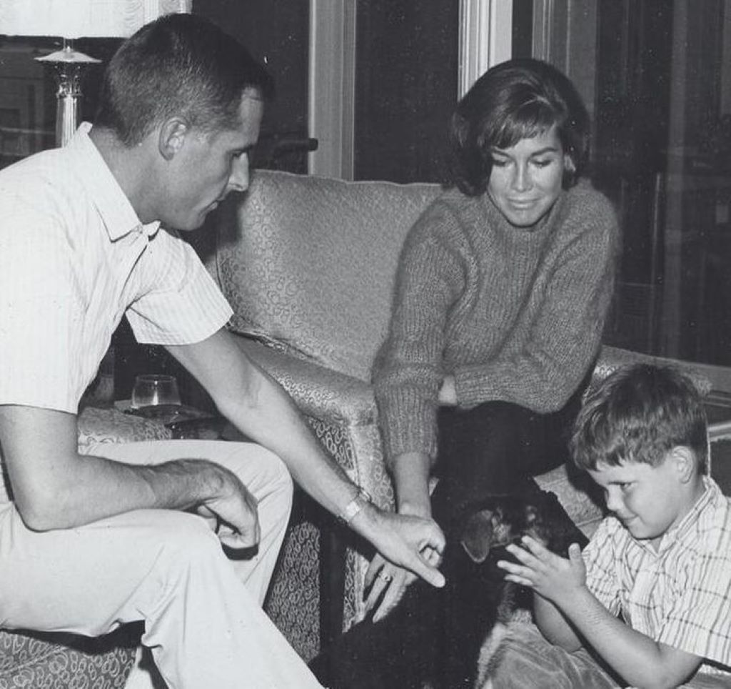 Young Richie Meeker playing with a dog
