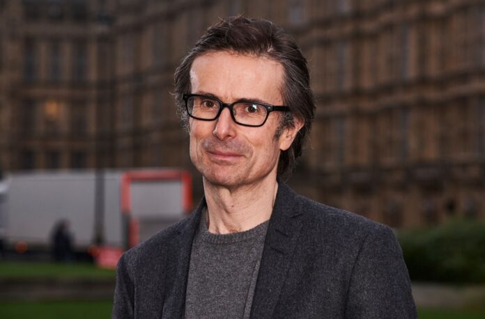 Robert Peston standing on the stage after his speech
