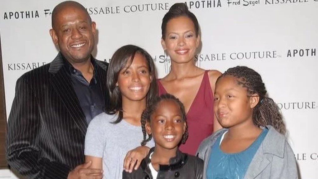 Keisha Nash with her kids and husband, everyone is smiling.