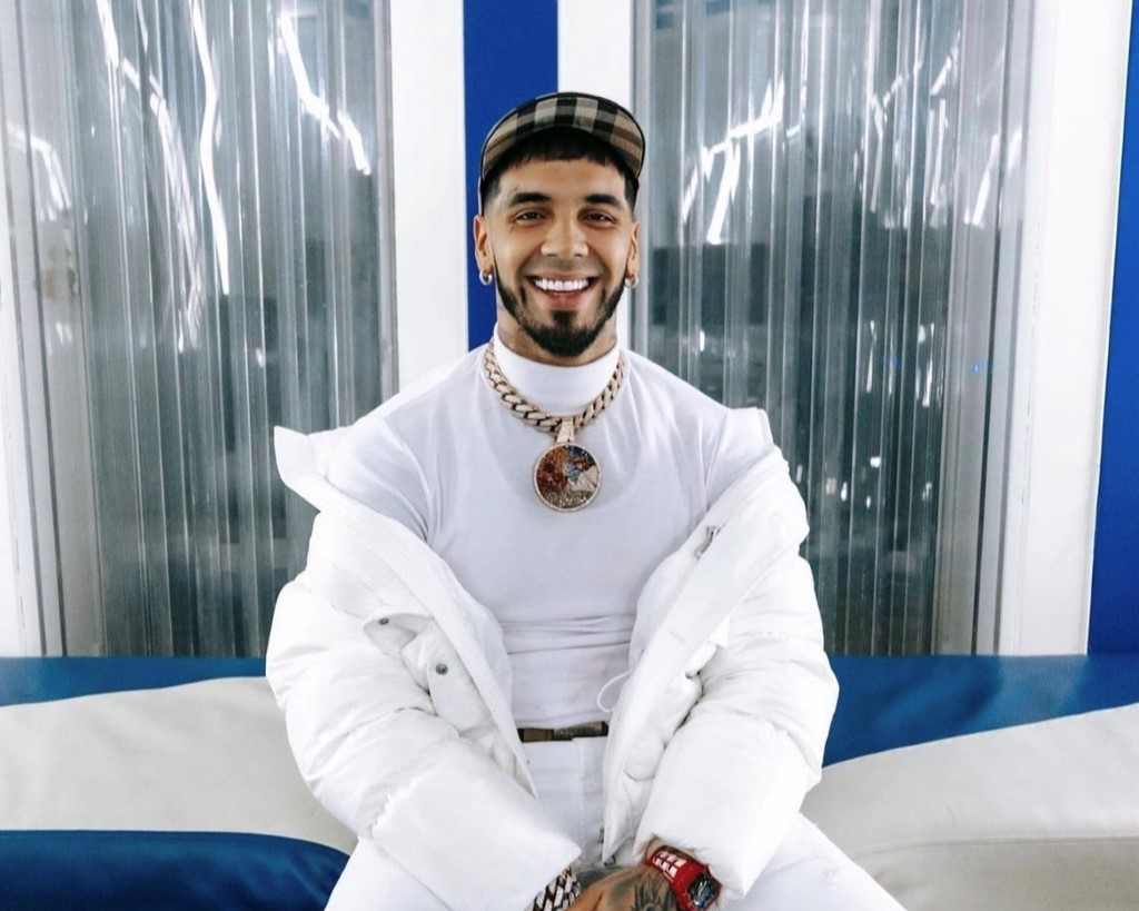 Anuel AA captured in all white dress.
