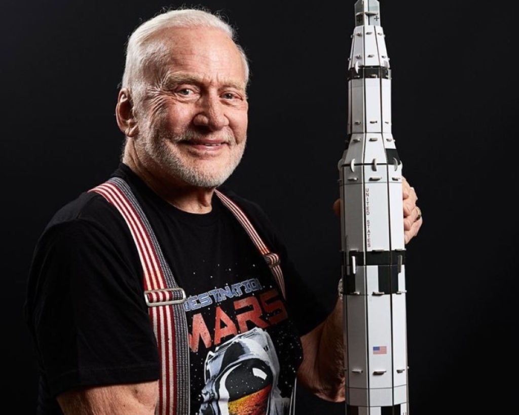 Buzz Aldrin holding a rocket model