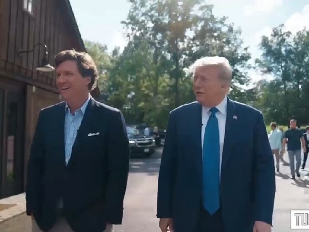 Tucker and Trump walking together.