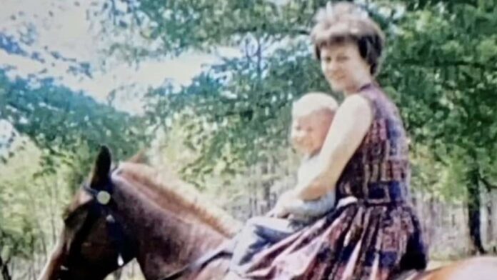 Elizabeth Sennitte captured along with a kid in a horse.