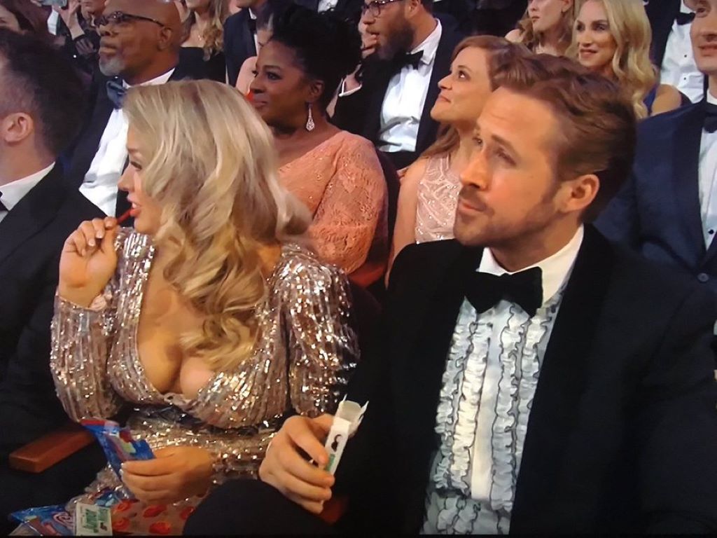 Mandi and Ryan Gosling sitting among crowd in Oscar 