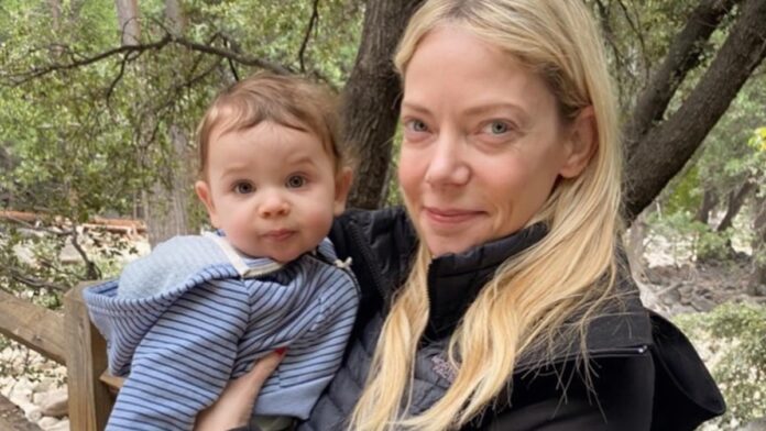 Riki Lindhome holding her son