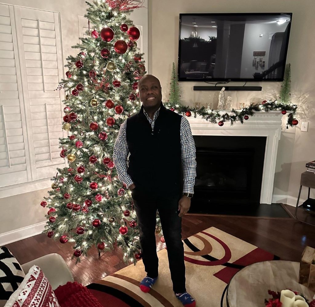 Tim Scott standing in front of Christmas tree