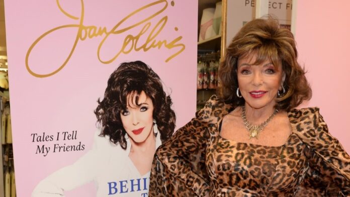 Joan Collins is seen wearing a spotted dress in a shot beside her poster.