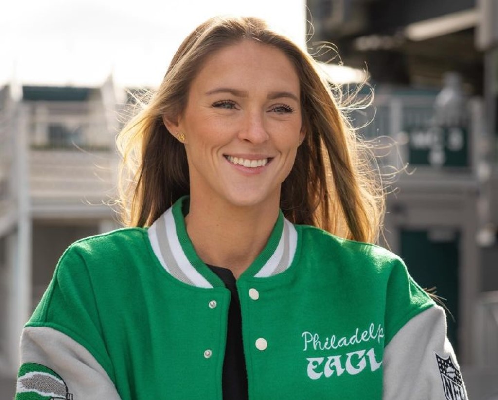 In the photo, Kylie is captured smiling while wearing a green jacket.
