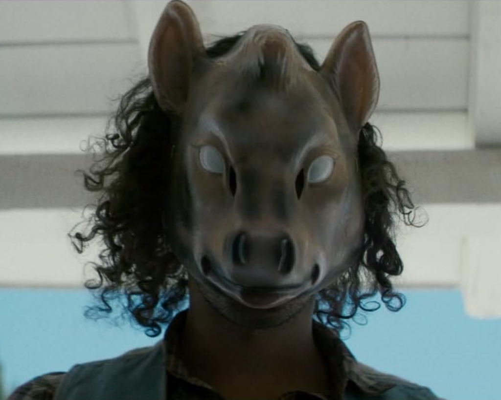 Character wearing a boar mask