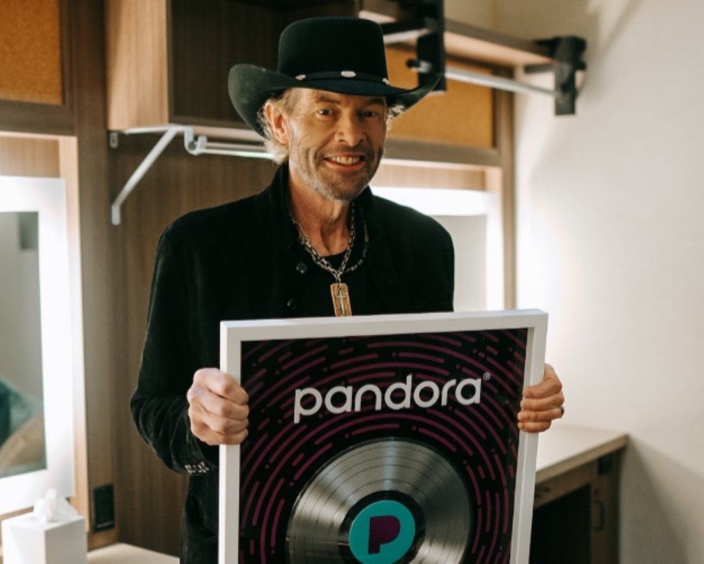 Toby Keith holding a platinum record