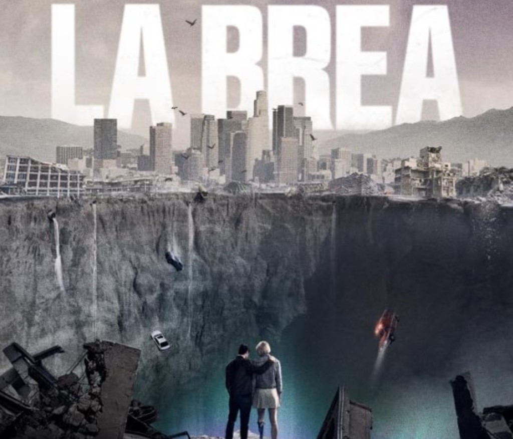 The theme picture of the La Brea series features a large sinkhole with two people standing at its edge.