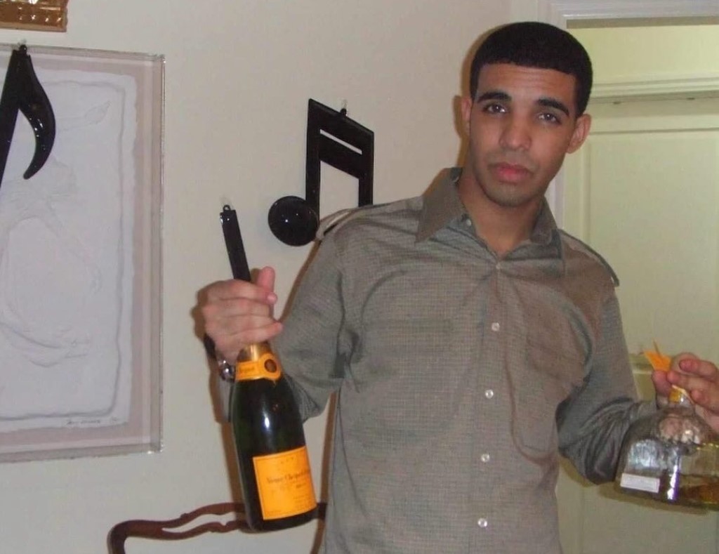 younger aubrey graham holding a bottle of wine